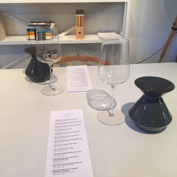 Ceritas Wines - a glass of wine and a menu on a table - Wineries Near Me - Healdsburg, California Ceritas Wines - a glass of wine and a menu on a table - Wineries Near Me - Healdsburg, California