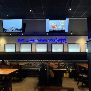 The Spot Lv - Eat what makes you happy is on a blue neon sign above the tables. - Sports Bars Near Me - Las Vegas, Nevada The Spot Lv - Eat what makes you happy is on a blue neon sign above the tables. - Sports Bars Near Me - Las Vegas, Nevada