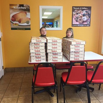 Donut Hole - two girls sitting at a table with boxes of donuts - Donuts Near Me - Gatesville, Texas
