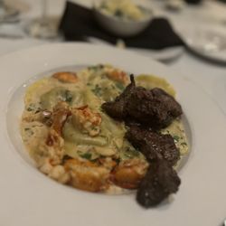 Michael John's - French-American Steakhouse - Surf and turf pasta and a side of creamed spinach.