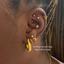 Angel Tattoo - Walk-in ear piercings at Angel Tattoo cartilage piercing with gold jewelry walk-in welcome