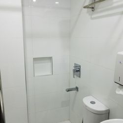 Eurotel - Shower inches away from the toilet. No shower curtains.