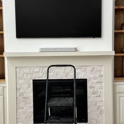 Eagles Home Services - Frame TV above fireplace.