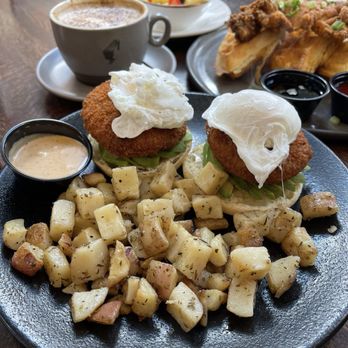 Kanela Breakfast Club - Crab Cake Benedict with potatoes and sauce on the side - Breakfast & Brunch Near Me - Chicago, Illinois Kanela Breakfast Club - Crab Cake Benedict with potatoes and sauce on the side - Breakfast & Brunch Near Me - Chicago, Illinois