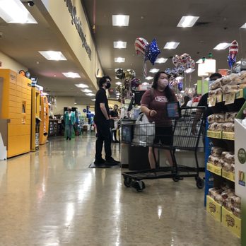 Safeway - a woman pushing a shopping cart in a grocery store - Grocery Near Me - Redding, California