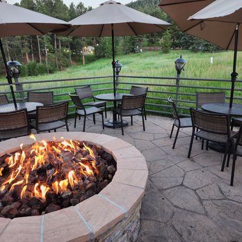 Chart House - a fire pit with tables and umbrellas - Seafood Near Me - Golden, Colorado