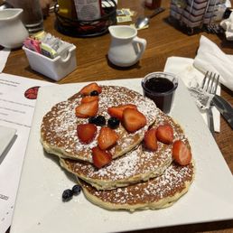 a stack of pancakes with strawberries and blueberries a stack of pancakes with strawberries and blueberries