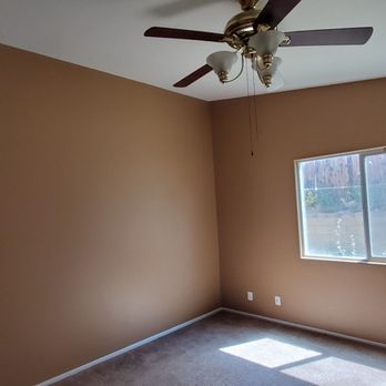BJM Construction - a room with a ceiling fan and a window - General Contractors Near Me - Hesperia, California