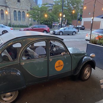Petit Robert Bistro - Cute decorative car near the patio seating - French Near Me - Boston, Massachusetts