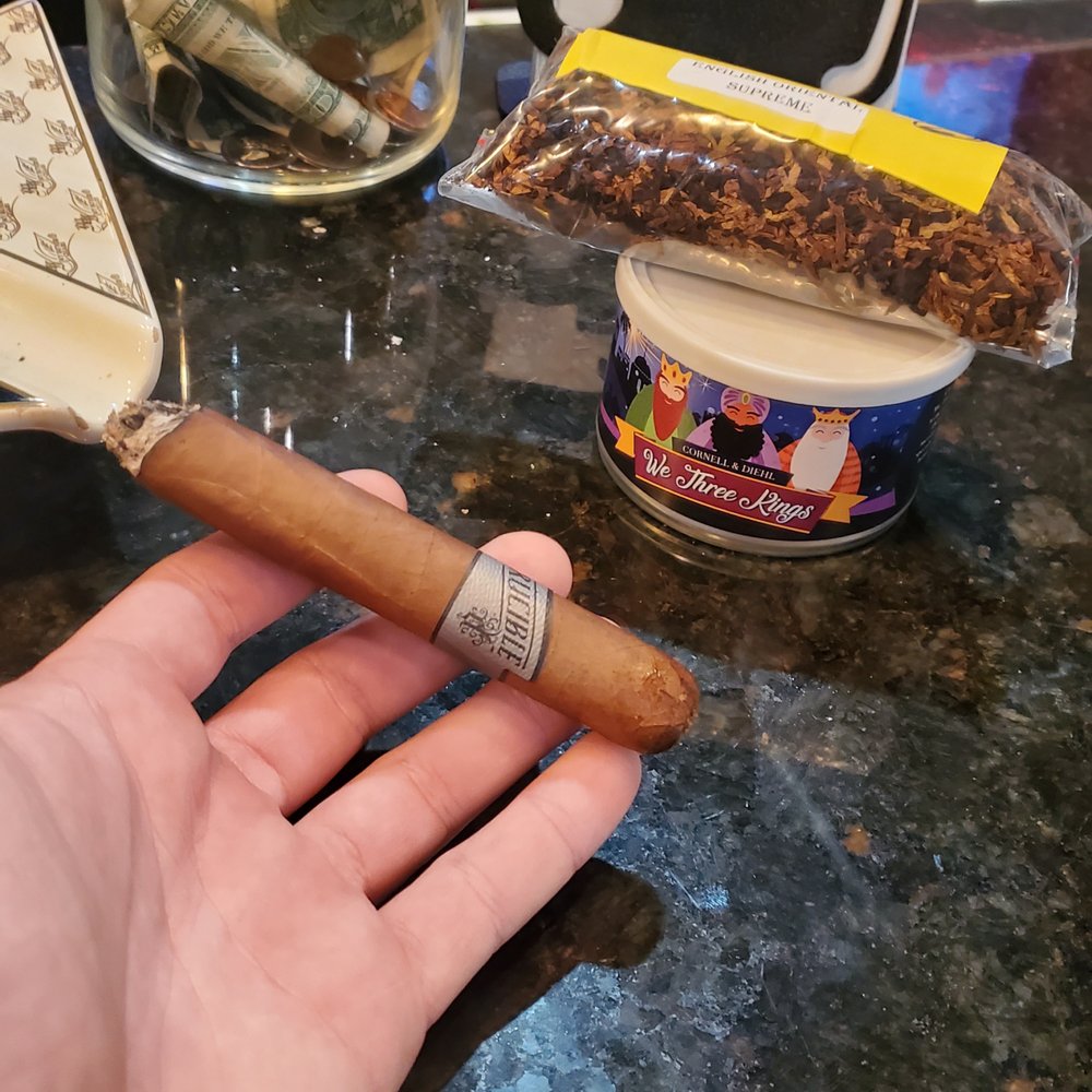 Boda Pipes and Cigar - a hand holding a cigar - Tobacco Shops Near Me - Greenville, South Carolina Boda Pipes and Cigar - a hand holding a cigar - Tobacco Shops Near Me - Greenville, South Carolina