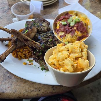 Aunt E’s Southern Cuisine - Lamb chops with Jollof rice, with mac and cheese, and loaded mash potatoes. - Chicken Wings Near Me - Greensboro, North Carolina Aunt E’s Southern Cuisine - Lamb chops with Jollof rice, with mac and cheese, and loaded mash potatoes. - Chicken Wings Near Me - Greensboro, North Carolina