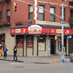 a pizza shop and a taxi on a city street