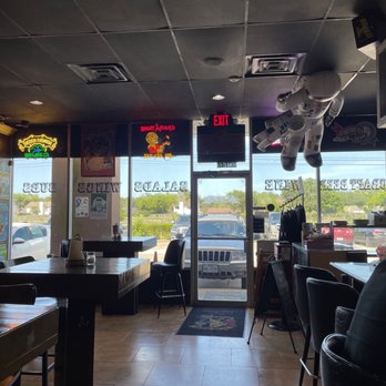 Dan's Pizza - a man sitting at a table in a restaurant - Pizza Near Me - Webster, Texas Dan's Pizza - a man sitting at a table in a restaurant - Pizza Near Me - Webster, Texas