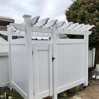 Liberty Fence & Railing - Custom outdoor shower enclosure featuring a pergola top with rafter tails we designed, fabricated, and installed in Oceanside, NY. - Fences & Gates Near Me - Elmont, New York Liberty Fence & Railing - Custom outdoor shower enclosure featuring a pergola top with rafter tails we designed, fabricated, and installed in Oceanside, NY. - Fences & Gates Near Me - Elmont, New York
