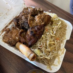 Plate with pancit, chicken adobo & lumpia
