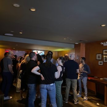 Stout NYC - a group of people standing in a bar - Irish Near Me - New York, New York