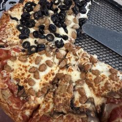 Pizza with sausage, mushroom and black olives.