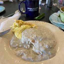 Biscuits with sausage gravy and a scrambled egg. Biscuits with sausage gravy and a scrambled egg.