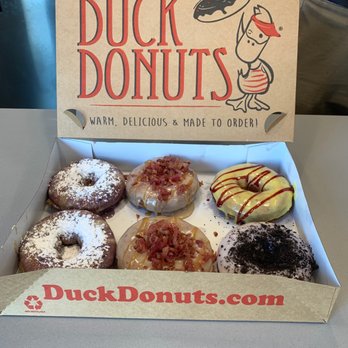 Duck Donuts - From left to right: two blueberry, two bacon, raspberry lemon, Oreo with vanilla icing. - Donuts Near Me - Irvine, California Duck Donuts - From left to right: two blueberry, two bacon, raspberry lemon, Oreo with vanilla icing. - Donuts Near Me - Irvine, California
