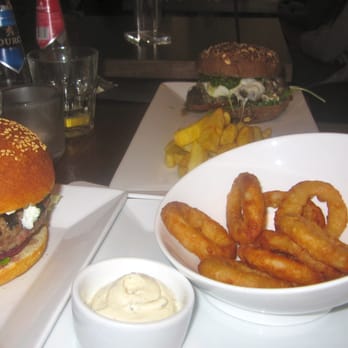 Burgerz - Lamb burger on left, onions rings with tzatziki sauce, and portebello mushroom burger with mozzarella and pesto sauce. - Burgers Near Me - Den Haag, ZH Burgerz - Lamb burger on left, onions rings with tzatziki sauce, and portebello mushroom burger with mozzarella and pesto sauce. - Burgers Near Me - Den Haag, ZH