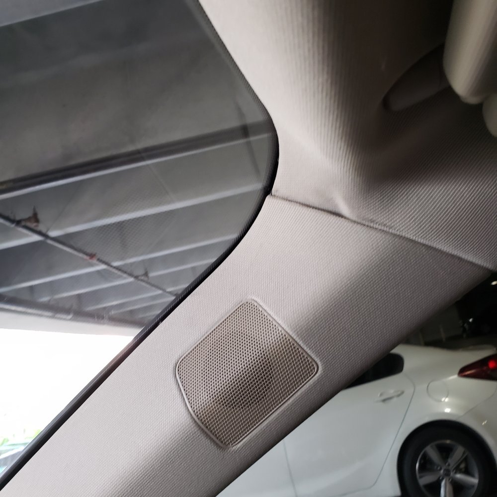 shows permanently dented headliner backboard and dirt/grease stains from install tools or hands.