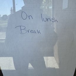 Closed for lunch sign at noon Closed for lunch sign at noon