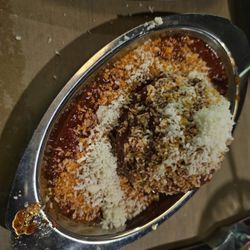 Delmonico's Italian Steakhouse - Side of a meatball.  The grated cheese was put on by the runner.