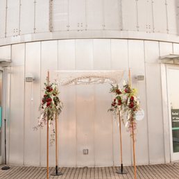Beautiful chuppah rented from Afikomen decorated with flowers by our florist