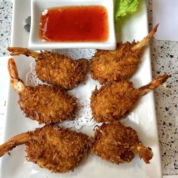 Thai On 1 - Crispy fried battered prawns breaded in shredded coconut served w/ plum sauce - Thai Near Me - Seattle, Washington Thai On 1 - Crispy fried battered prawns breaded in shredded coconut served w/ plum sauce - Thai Near Me - Seattle, Washington