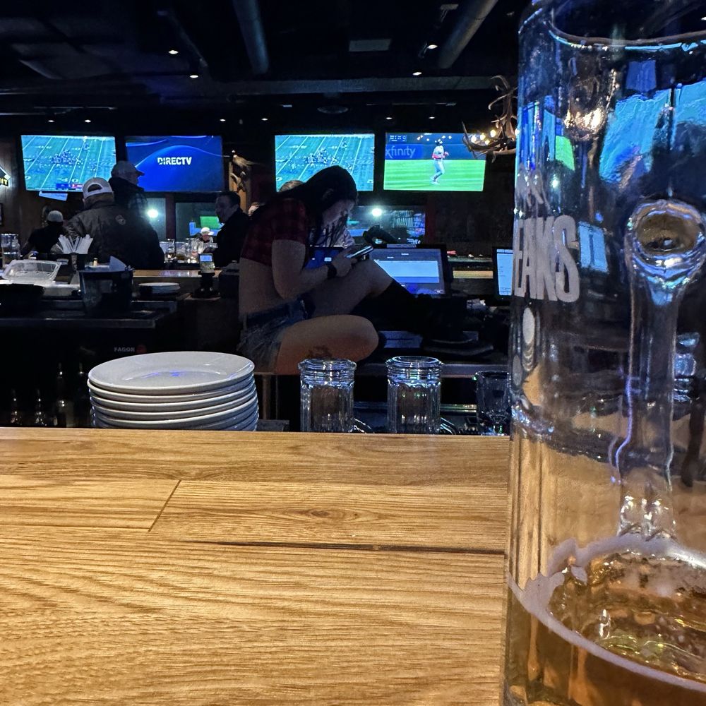 Twin Peaks - Waitress on her phone - Sports Bars Near Me - Fargo, North Dakota