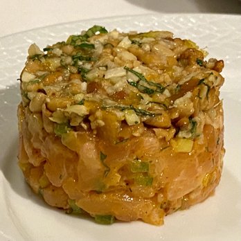 Emeril's - Salmon Tartare "Tagine" with Toasted Pine Nuts, Preserved Kumquats, Amahari, and Shabazi Cream - New American Near Me - New Orleans, Louisiana Emeril's - Salmon Tartare "Tagine" with Toasted Pine Nuts, Preserved Kumquats, Amahari, and Shabazi Cream - New American Near Me - New Orleans, Louisiana