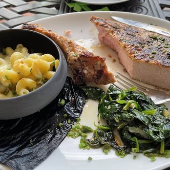 Palace - Berkshire bone-in pork loin chop with green Chile Mac and cheese and sautéed spinach. - Seafood Near Me - Santa Fe, New Mexico