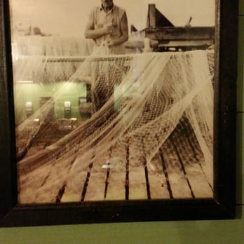 Crawfish Hut - a man in a fishing net - Cajun/Creole Near Me - Rayne, Louisiana