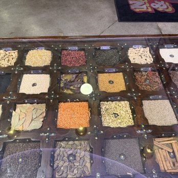 Naan & Curry - Table with assorted spices under the glass. - Indian Near Me - Las Vegas, Nevada Naan & Curry - Table with assorted spices under the glass. - Indian Near Me - Las Vegas, Nevada