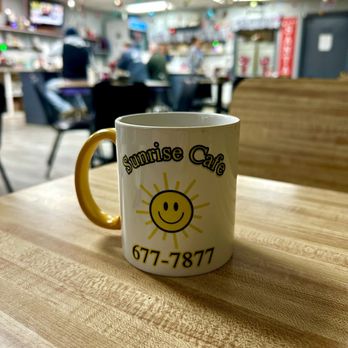 Sunrise Cafe - a coffee mug with a smiley face on it - Cafes Near Me - Ormond Beach, Florida
