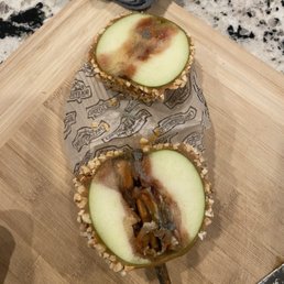 two apple slices on a cutting board