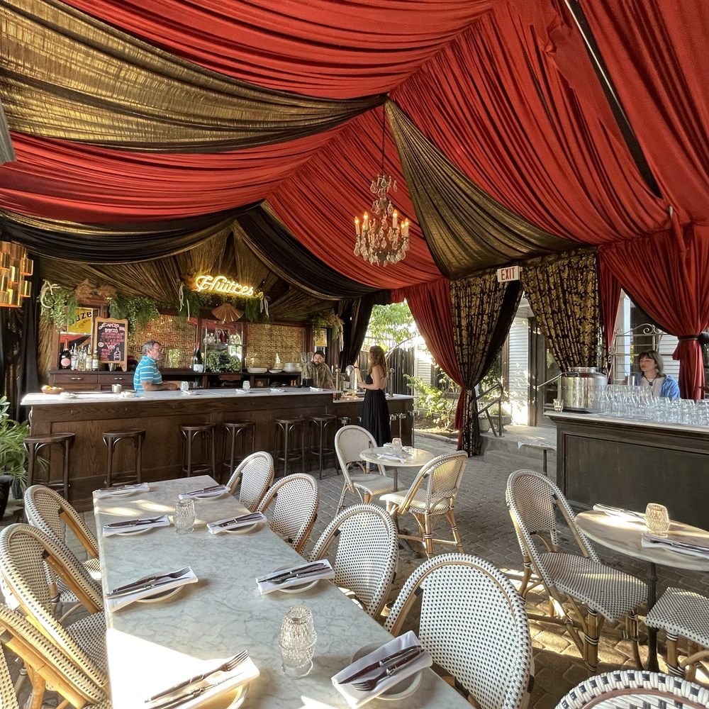 Justine's Brasserie - The outdoor patio bar area - French Near Me - Austin, Texas Justine's Brasserie - The outdoor patio bar area - French Near Me - Austin, Texas