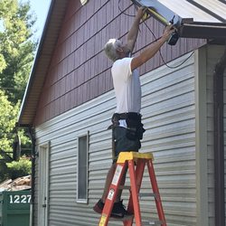 Winegardner Roofing - Installing metal rake edge on metal roof.