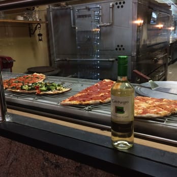 Lisa's Luna Pizza - Wine and slices of pizza ready to go at the counter. - Italian Near Me - Simsbury, Connecticut Lisa's Luna Pizza - Wine and slices of pizza ready to go at the counter. - Italian Near Me - Simsbury, Connecticut