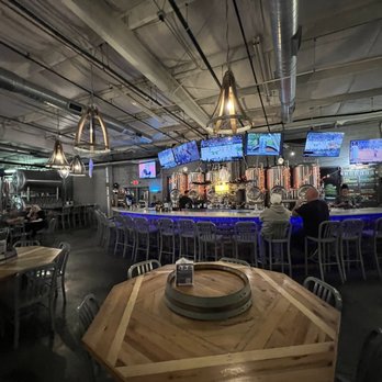 Akademia Brewing Company - a bar with a wooden table and chairs - Brewpubs Near Me - Athens, Georgia Akademia Brewing Company - a bar with a wooden table and chairs - Brewpubs Near Me - Athens, Georgia
