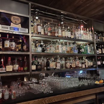 Alibi Room - shelves of alcohol bottles and glasses - New American Near Me - Seattle, Washington Alibi Room - shelves of alcohol bottles and glasses - New American Near Me - Seattle, Washington