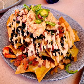 Lamplight Lounge - $21 Lobster Nachos – A MUST GET! A wonderful dish to enjoy while dining at the outdoor patio overlooking the Mickey Mouse Ferris Wheel. - New American Near Me - Anaheim, California