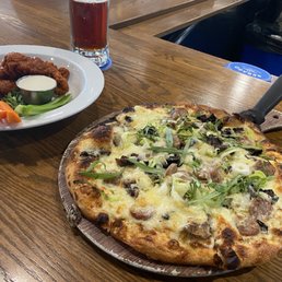 Mushroom truffle oil pizza, added Italian sausage. Also to the left is the boneless Buffalo wings.