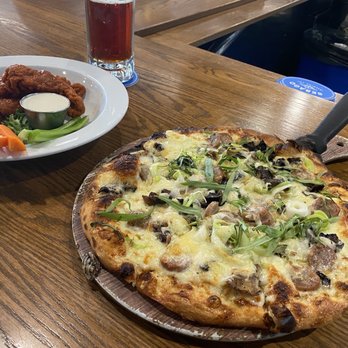 Sebago Brewing Company - Mushroom truffle oil pizza, added Italian sausage. Also to the left is the boneless Buffalo wings. - Breweries Near Me - Gorham, Maine