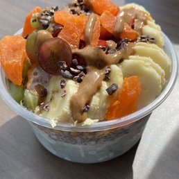 Small bowl with Blue Majic, Vanilla, Chai pudding, granola, honey, banana, strawberry, kiwi, dried mango and almond butter. Small bowl with Blue Majic, Vanilla, Chai pudding, granola, honey, banana, strawberry, kiwi, dried mango and almond butter.
