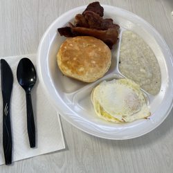 Milly's Cafe - Two eggs over easy, bacon, grits and biscuit