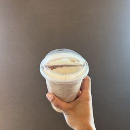 a hand holding a cup of coffee a hand holding a cup of coffee