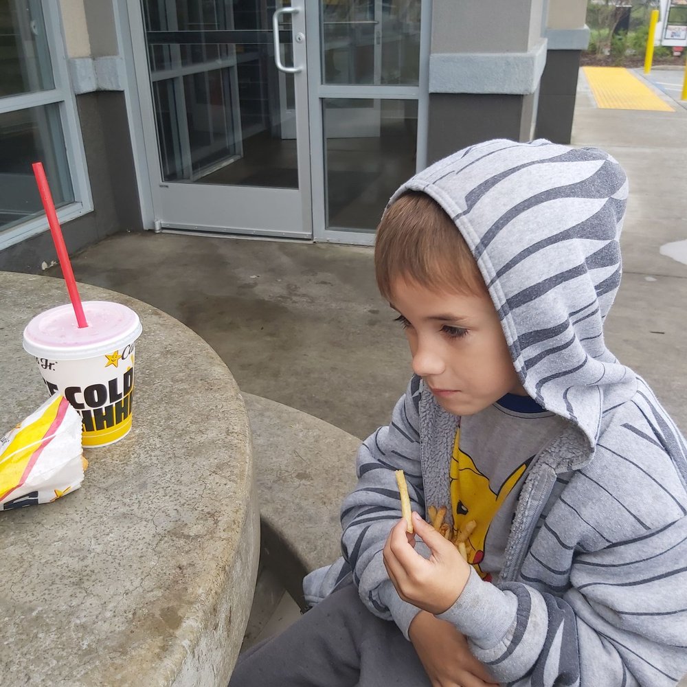 a young boy eating a donut a young boy eating a donut