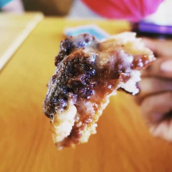 Cinnaholic - a person holding a piece of food - Bakeries Near Me - Pittsburgh, Pennsylvania Cinnaholic - a person holding a piece of food - Bakeries Near Me - Pittsburgh, Pennsylvania