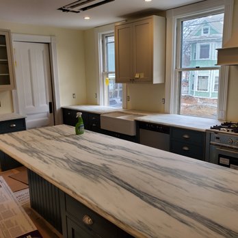 Phillips Quartz and Cabinets - a kitchen with a marble countertop - Drywall Installation & Repair Near Me Phillips Quartz and Cabinets - a kitchen with a marble countertop - Drywall Installation & Repair Near Me